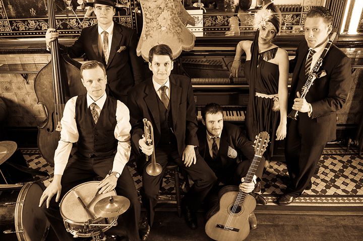 Jazz band with instruments in front of a piano